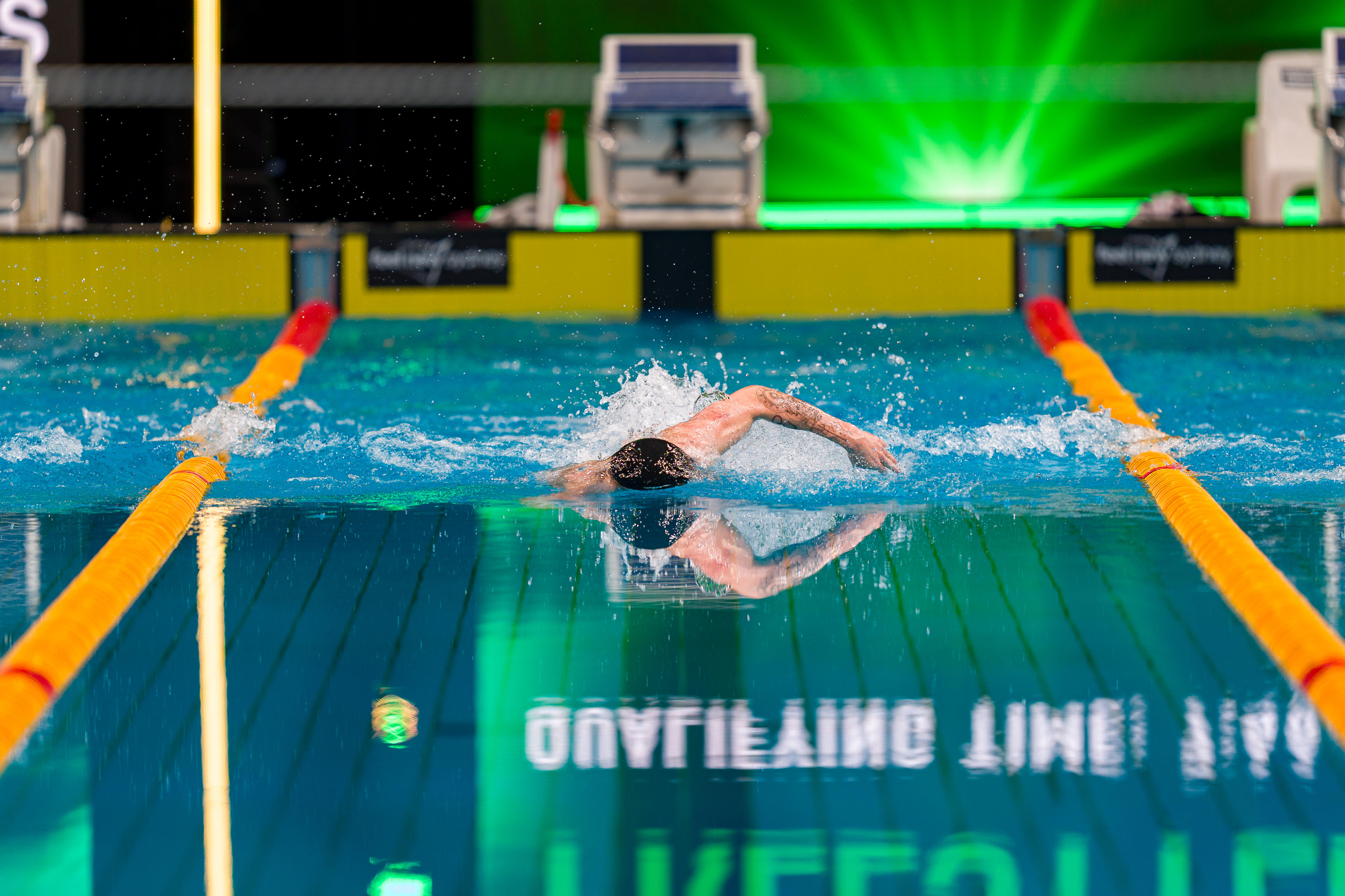 Sam Short, unidentifiable, swims towards the camera at the Australian Swimming Trials.