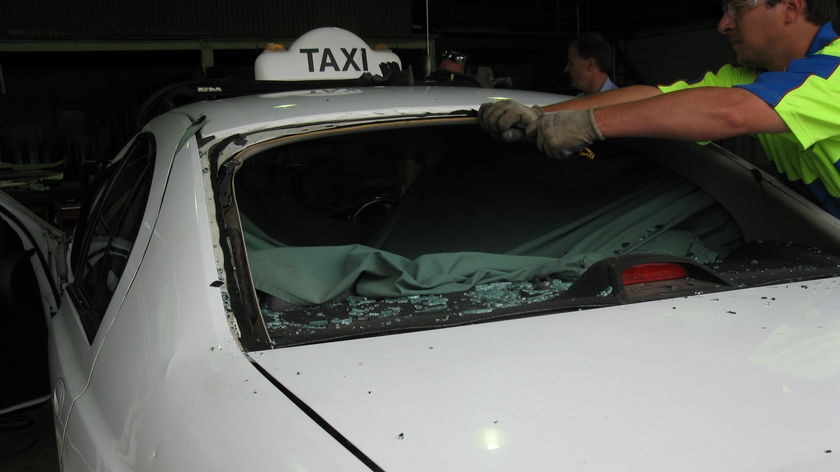 An Alice Springs taxi being repaired after an attack by up to 30 people.