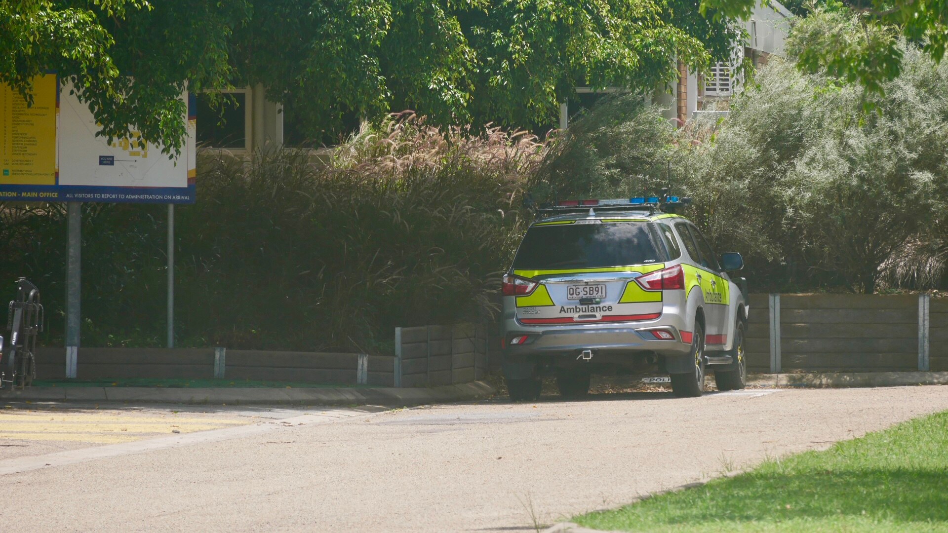 Ambulance vehicle outside high school.