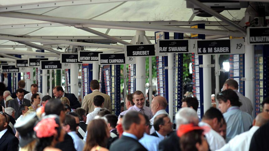 Punters place bets with the bookmakers at Flemington