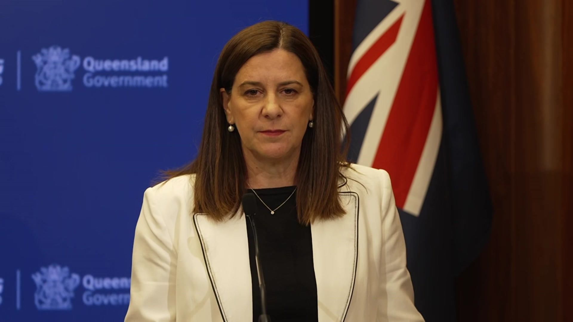 A woman in a white blazer with a black shirt.