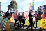 people walking waiting to vote