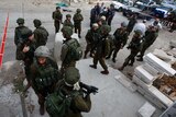 Israeli security forces gather at the scene of a stabbing attack against an Israeli soldier in Hebron, West Bank.