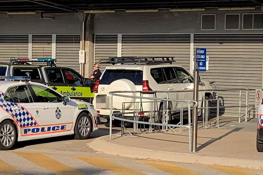 White four-wheel-drive with police cars blocking it at Townsville Hospital.