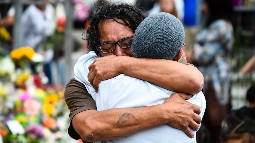 People embrace at the Kilbirnie Mosque in Wellington