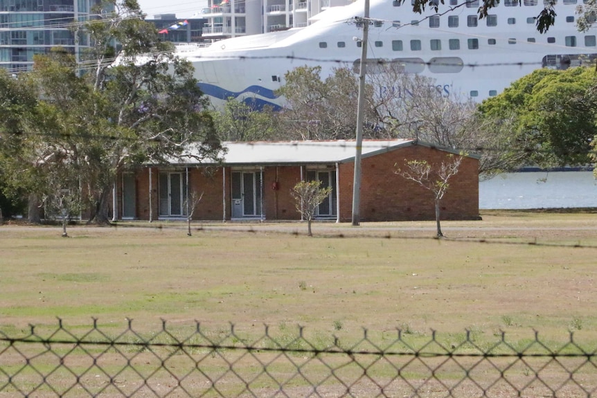 A shot of the Bulimba Barracks shows an old brick building.