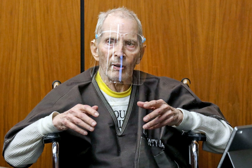 Robert Durst in a face shield answers questions from the defence attorney during his murder trial