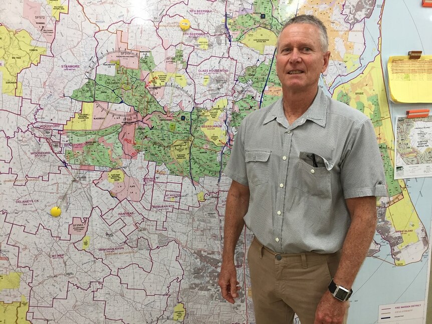 Man standing in front of a detailed wall map