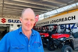 David Mims stands in front of side-by-side ATVs