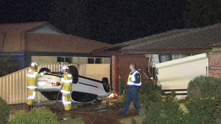 This upturned car crashed into a Thornlie house