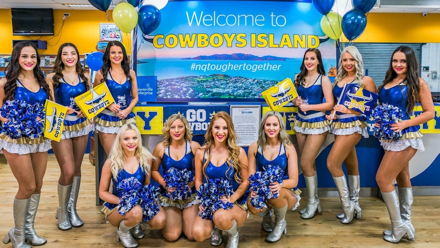 The NRL team the North Queensland Cowboys' cheer squad stand in formation at the Magnetic Island ferry terminal