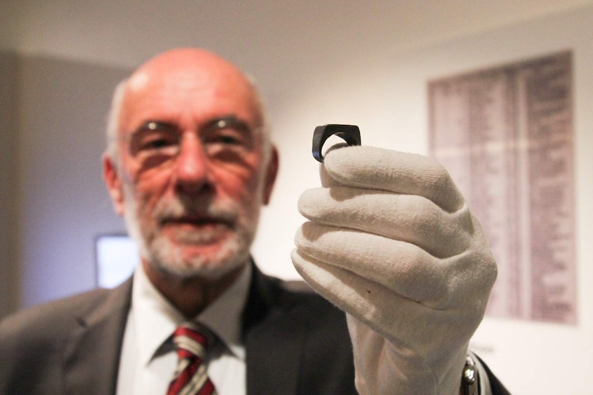 Louis Gross holds the led model ring his father, Jozef Gross, made for Oskar Schindler's ring in 1945.
