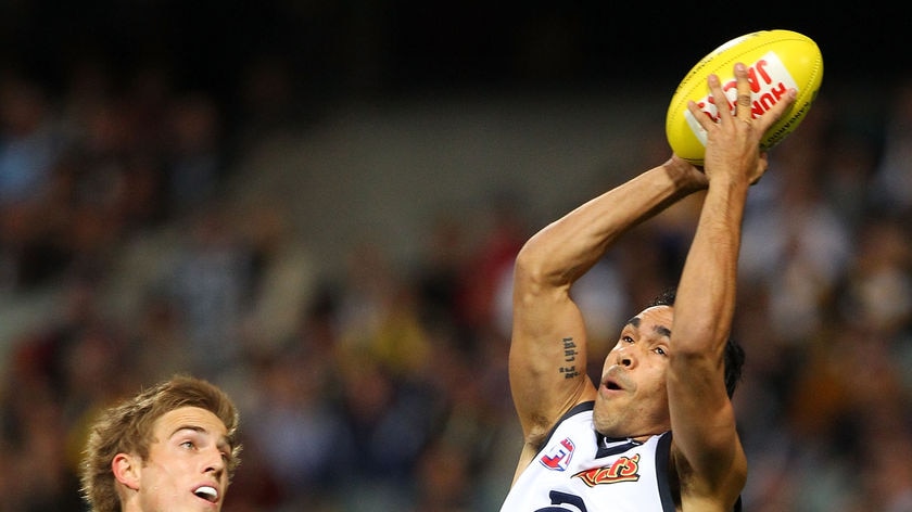 Eddie Betts takes a mark for Carlton as Brad Sheppard of the Eagles looks on.