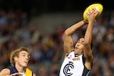 Eddie Betts takes a mark for Carlton as Brad Sheppard of the Eagles looks on.