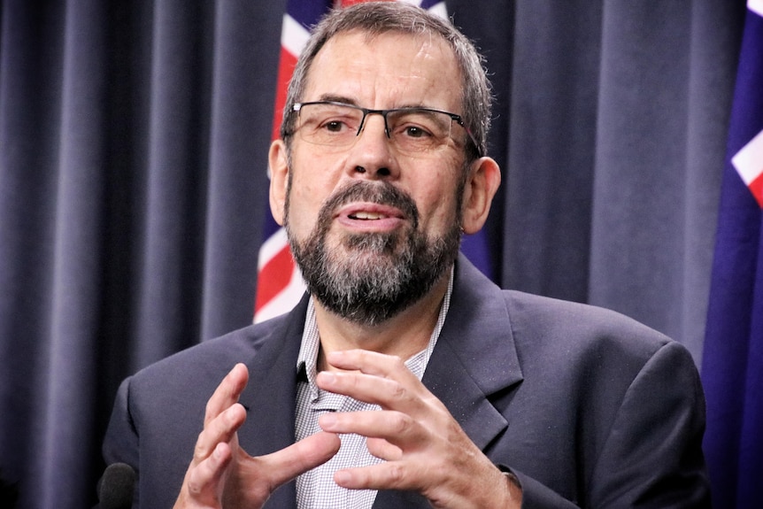 A head and shoulder shot of WA's Chief Health Officer Dr Andrew Robertson addressing the media.