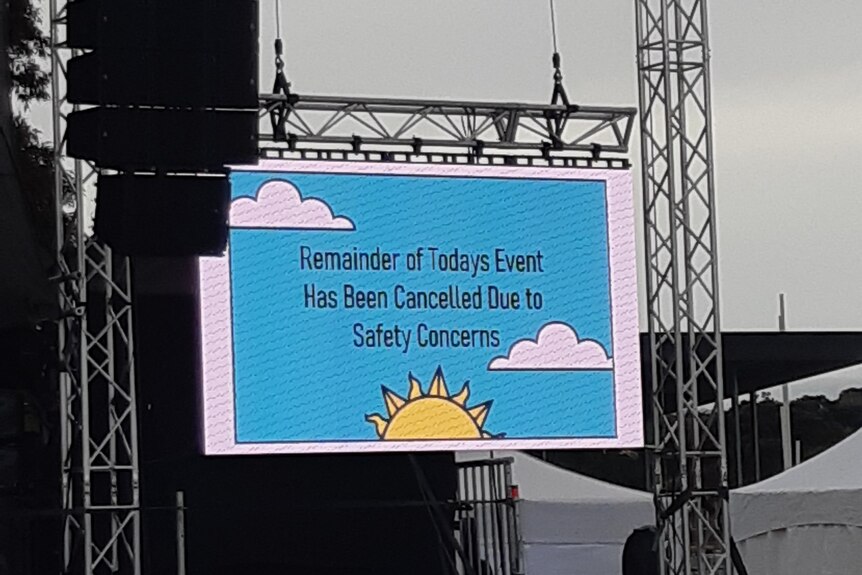A sign at an event saying 'remainder of today's event has been cancelled due to safety concerns'.