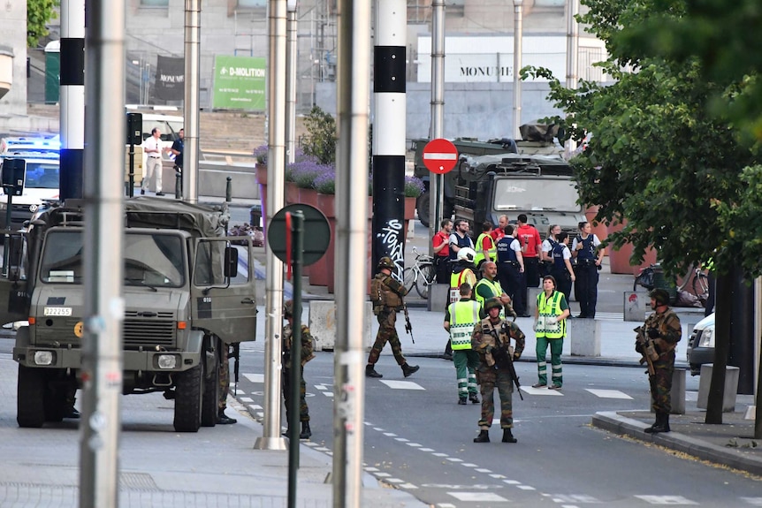 Belgian Army soldiers and police patrol outside Central Station after a reported explosion.