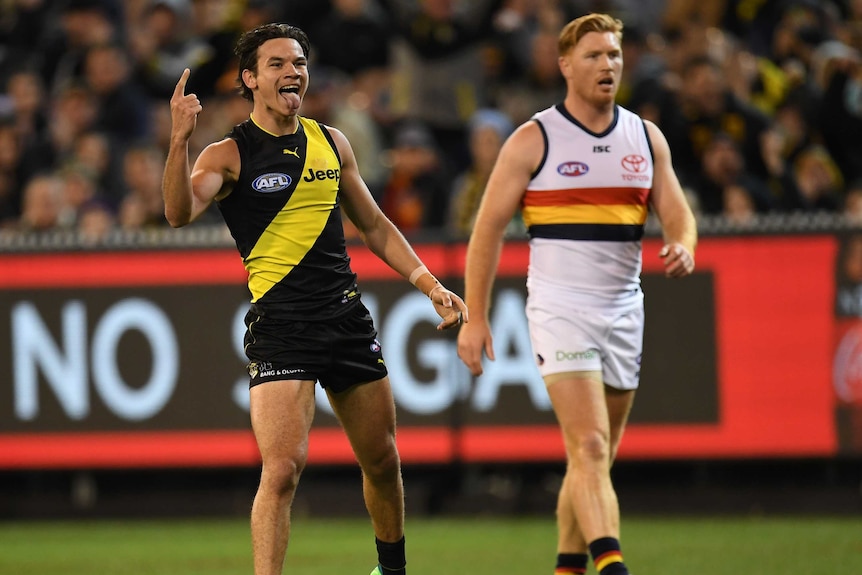 Daniel Rioli raises a finger on his right hand as he celebrates a goal against Adelaide.