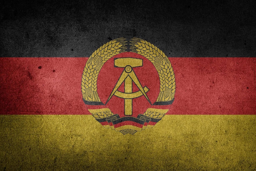 A faded, gritty German Democratic Republic (GDR) flag