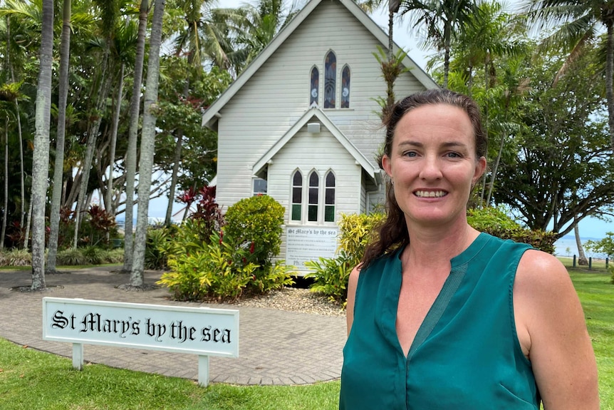 Tara Bennett stands outside St Mary's Church in Port Douglas.