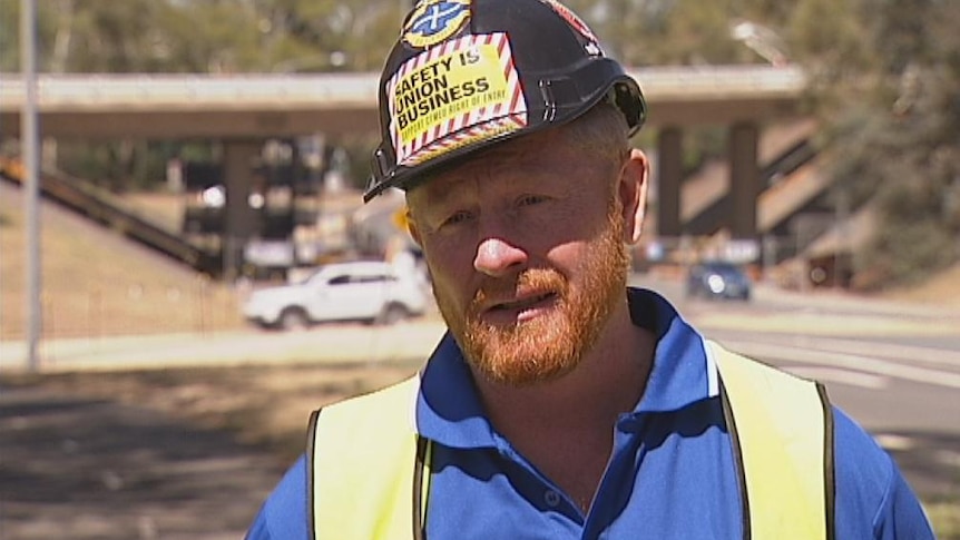 CFMEU ACT branch secretary Dean Hall in front bridge works at Parkes Way in 2013.
