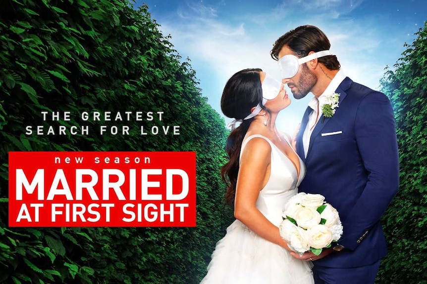A blindfolded man and woman in wedding attire are almost kissing on this ad for Nine's Married At First Sight.