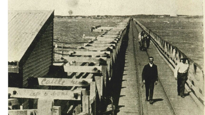 A black-and-white photo of people standing on Carnarvon's One Mile Jetty.