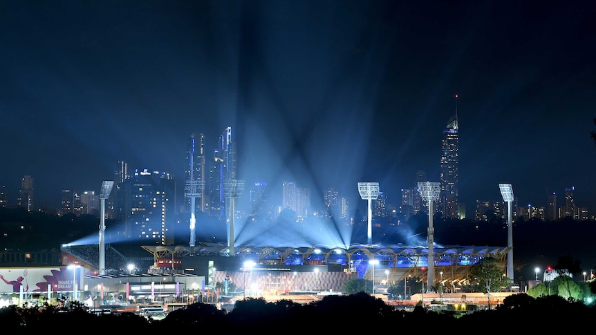 Carrara Stadium is lit up with blue lights for the opening ceremony.