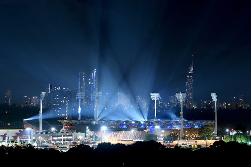 Carrara Stadium is lit up with blue lights for the opening ceremony.