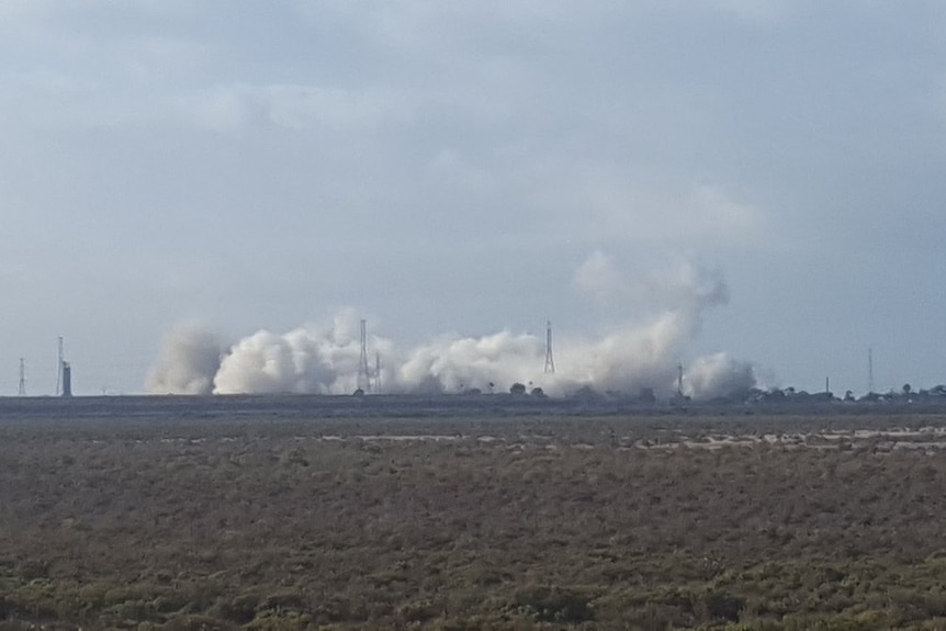 Dust clouds rise from Port Augusta power station demolition.