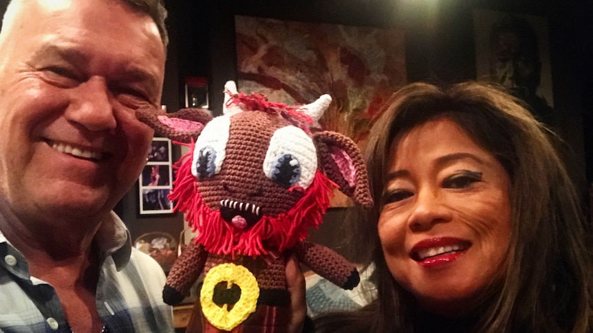 Jimmy Barnes and his wife hold a crochet G'Nu