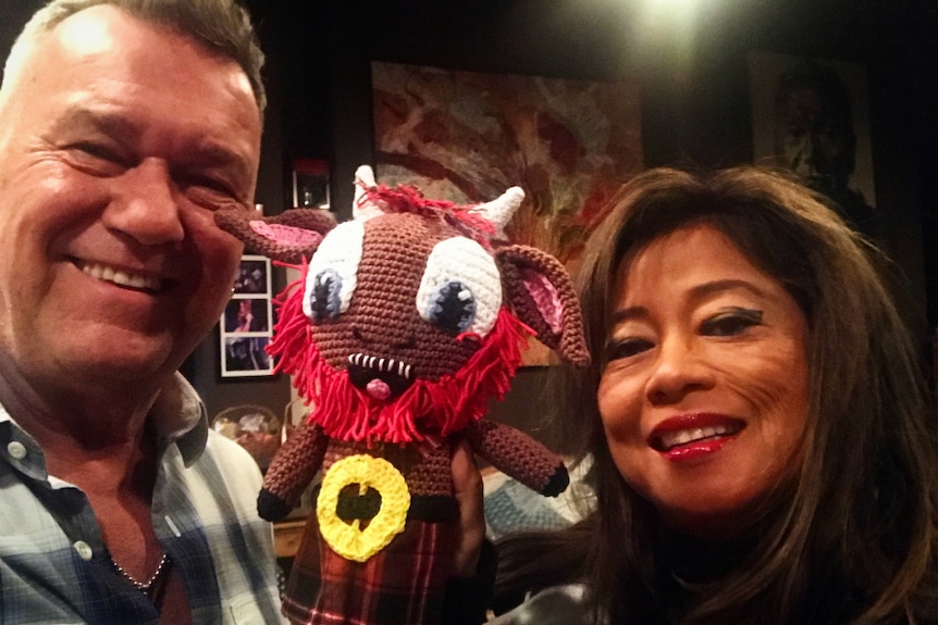 Jimmy Barnes and his wife hold a crochet G'Nu