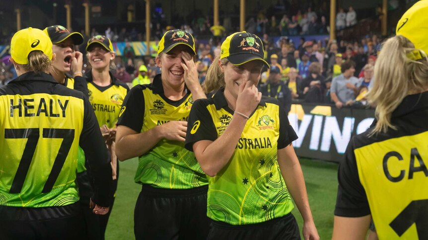 An emotional team congratulates each other after winning the Women's T20 World Cup semi-final.
