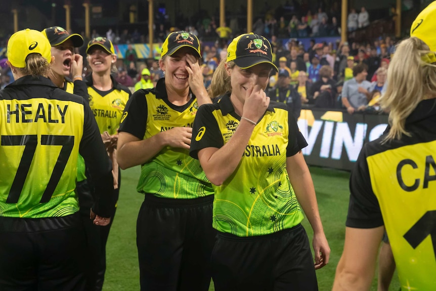 An emotional team congratulates each other after winning the Women's T20 World Cup semi-final.