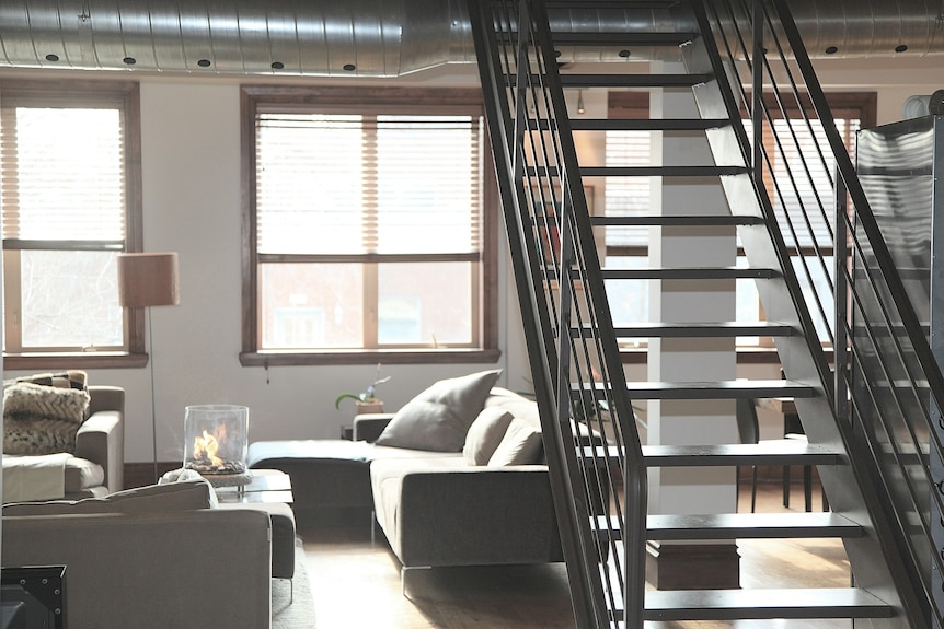 Apartment with metal frame staircase.