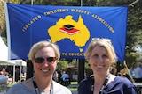 Edwina Hick and Jessie Persse stand in front of the ICPA banner.