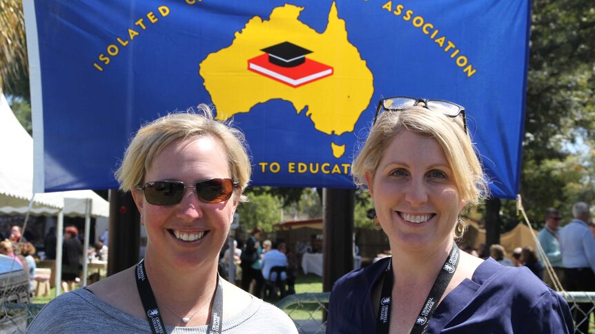 Edwina Hick and Jessie Persse stand in front of the ICPA banner.