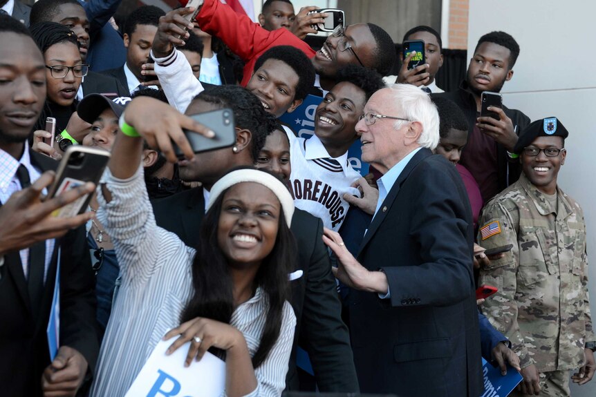 Bernie Sanders surrounded by young black supporters