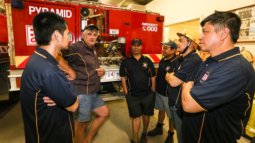 Pyramid Hill Captain Steve Mann talking to five members of the Filipino new CFA volunteers.