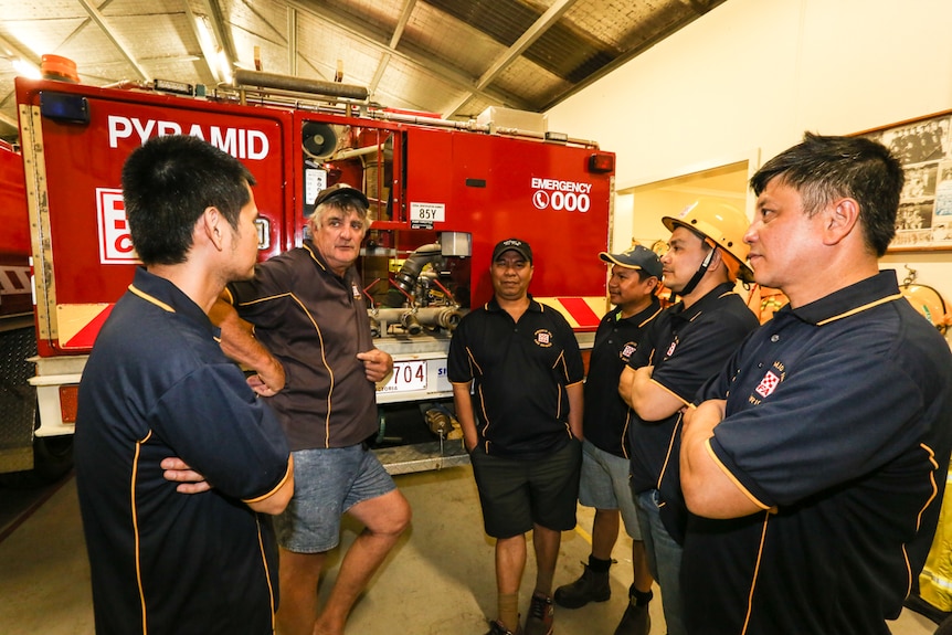 Pyramid Hill Captain Steve Mann talking to five members of the Filipino new CFA volunteers.