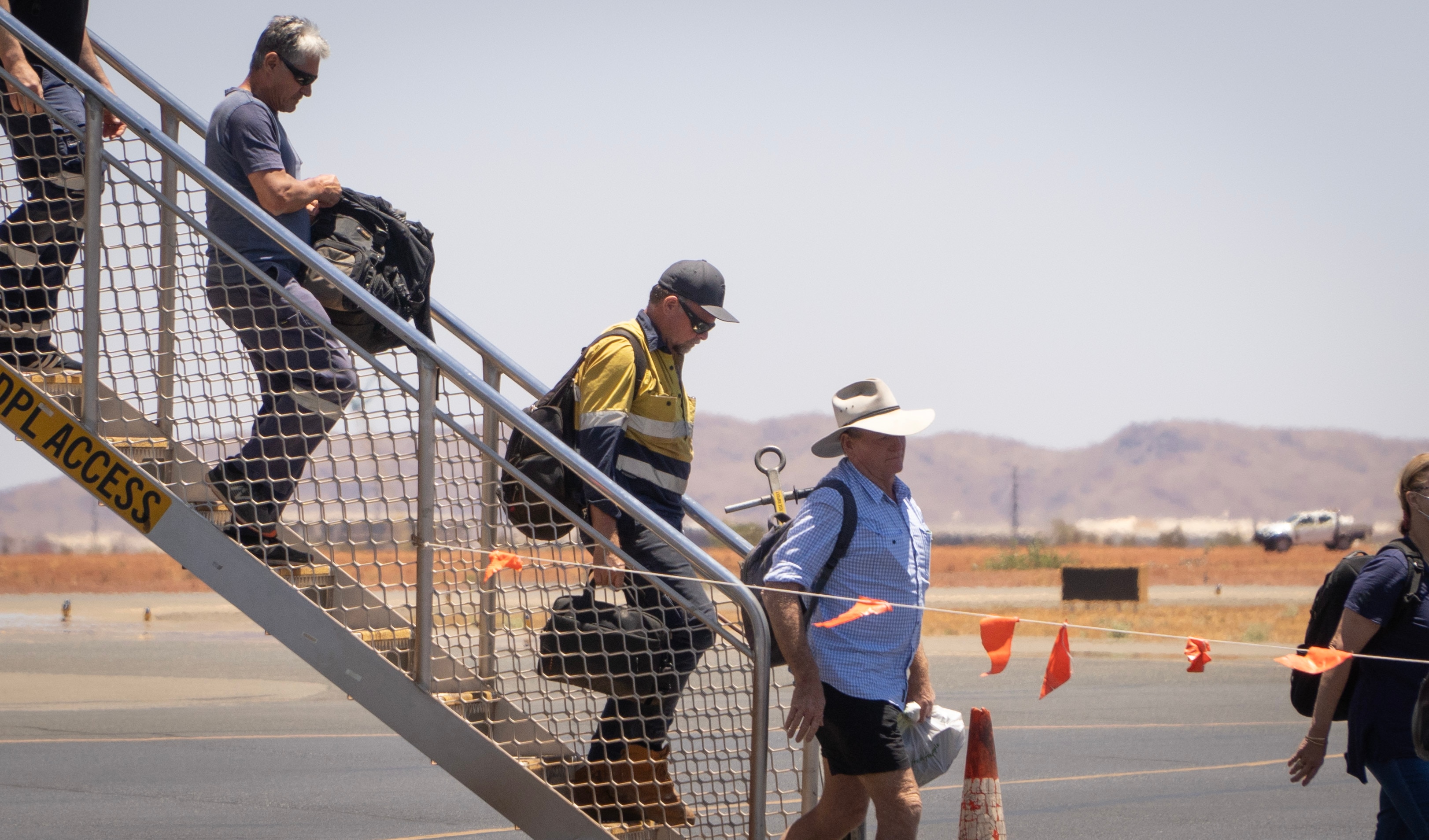 FIFO workers disembarking from a plane.