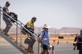 FIFO workers disembarking from a plane.