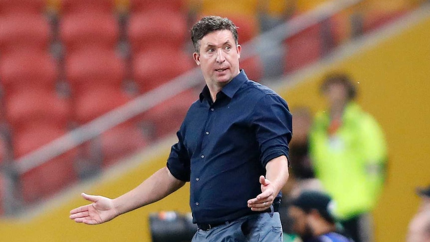 Brisbane Roar coach Robbie Fowler shrugs while on the sidelines at Lang Park.