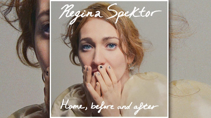 Regina Spektor has her hands over her mouth. Her fingernails are painted with numbers, hearts, dots