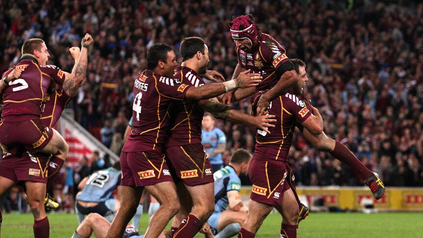 What a win ... Cameron Smith (R) lifts up Johnathan Thurston after the Maroons' win