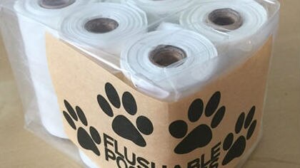 Six rolls of plastic bags packaged with the text 'flushable poop bags'.