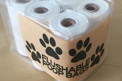 Six rolls of plastic bags packaged with the text 'flushable poop bags'.