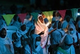 Ethiopian Orthodox Christians light candles and pray for peace during a church service.
