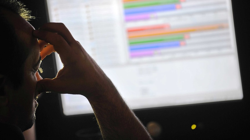 Man looks anxious in front of computer screen