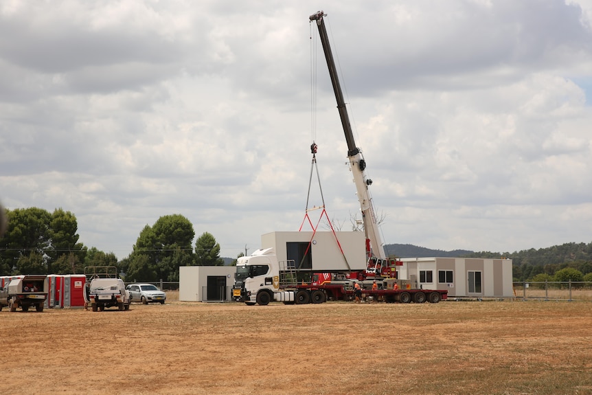 Pod home being craned onto truck